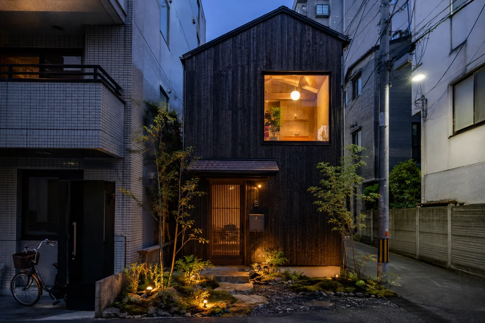 Modern townhouse with dark cedar cladding at dusk
